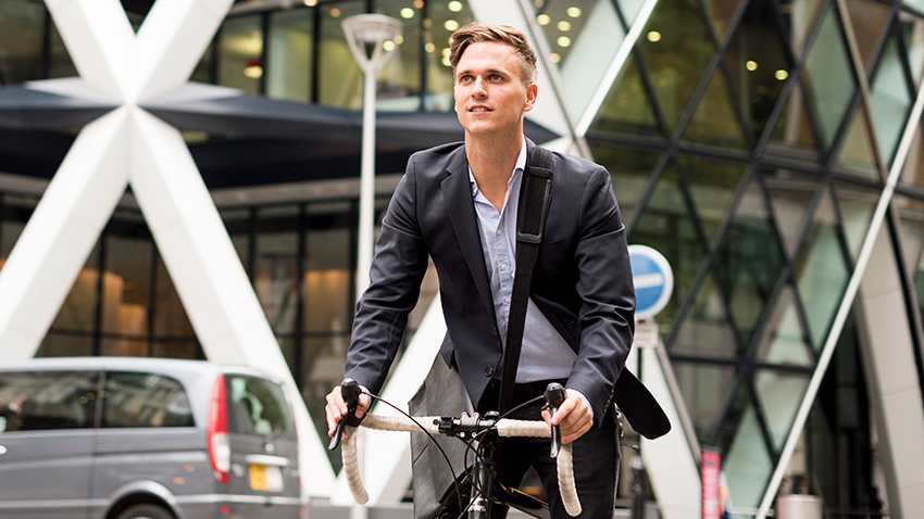 Young professional man riding a bicycle in London