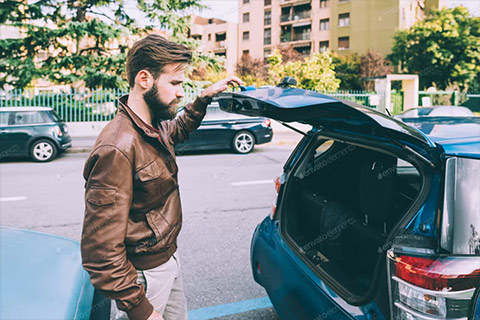 Man looking into the boot of his car
