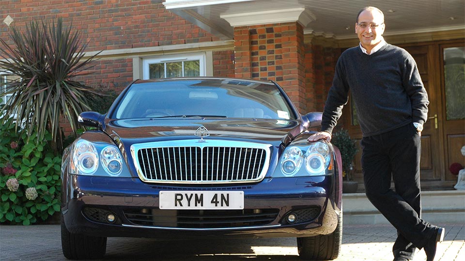 Theo Paphitis leaning against his car which has the number plate RYM 4N on it.