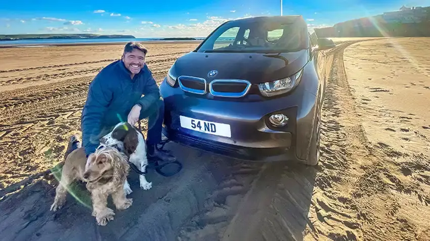 James Heaven on the beach with his car bearing the registration 54 ND